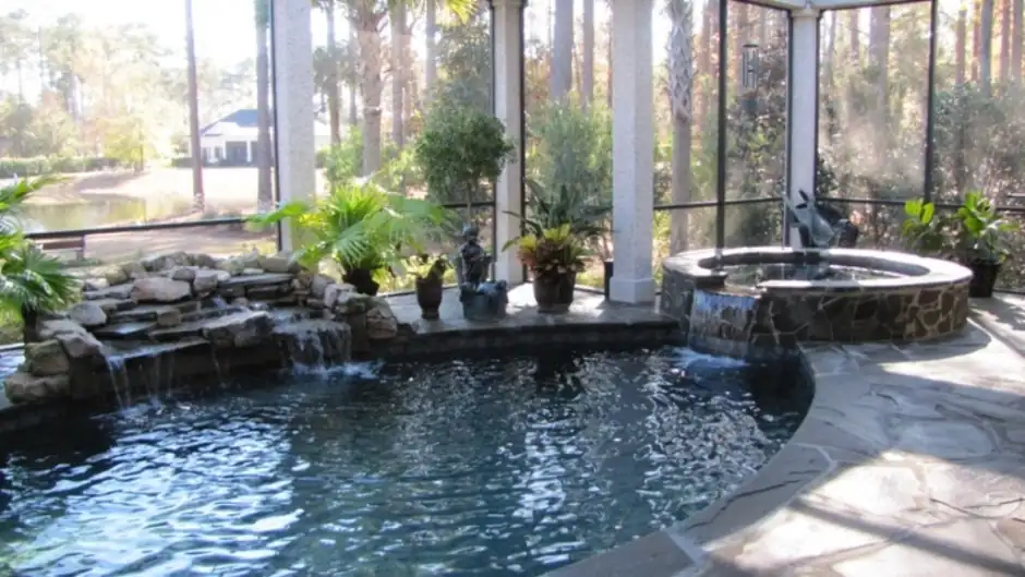 Screened indoor pool and spa with flagstone decking